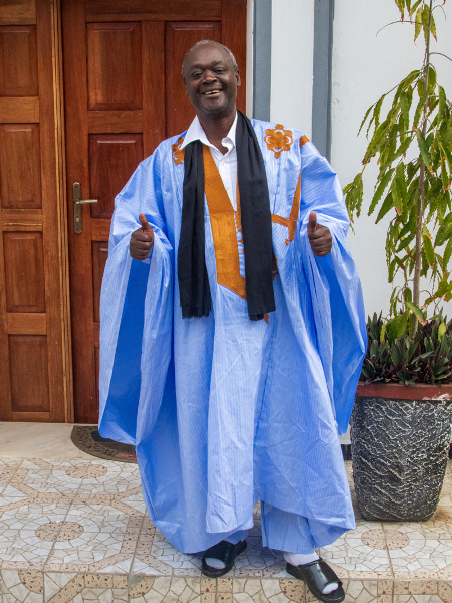 My gracious host, Modibo, outside of his hotel, La Maison Blanche, on his way to prayer in his grand boubou