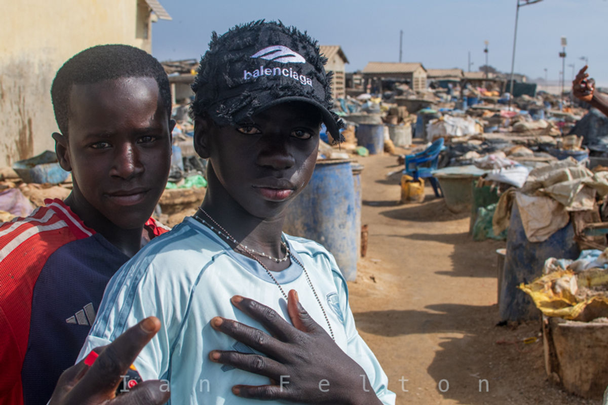 Two teenagers pose for a photo in the salt preservation area